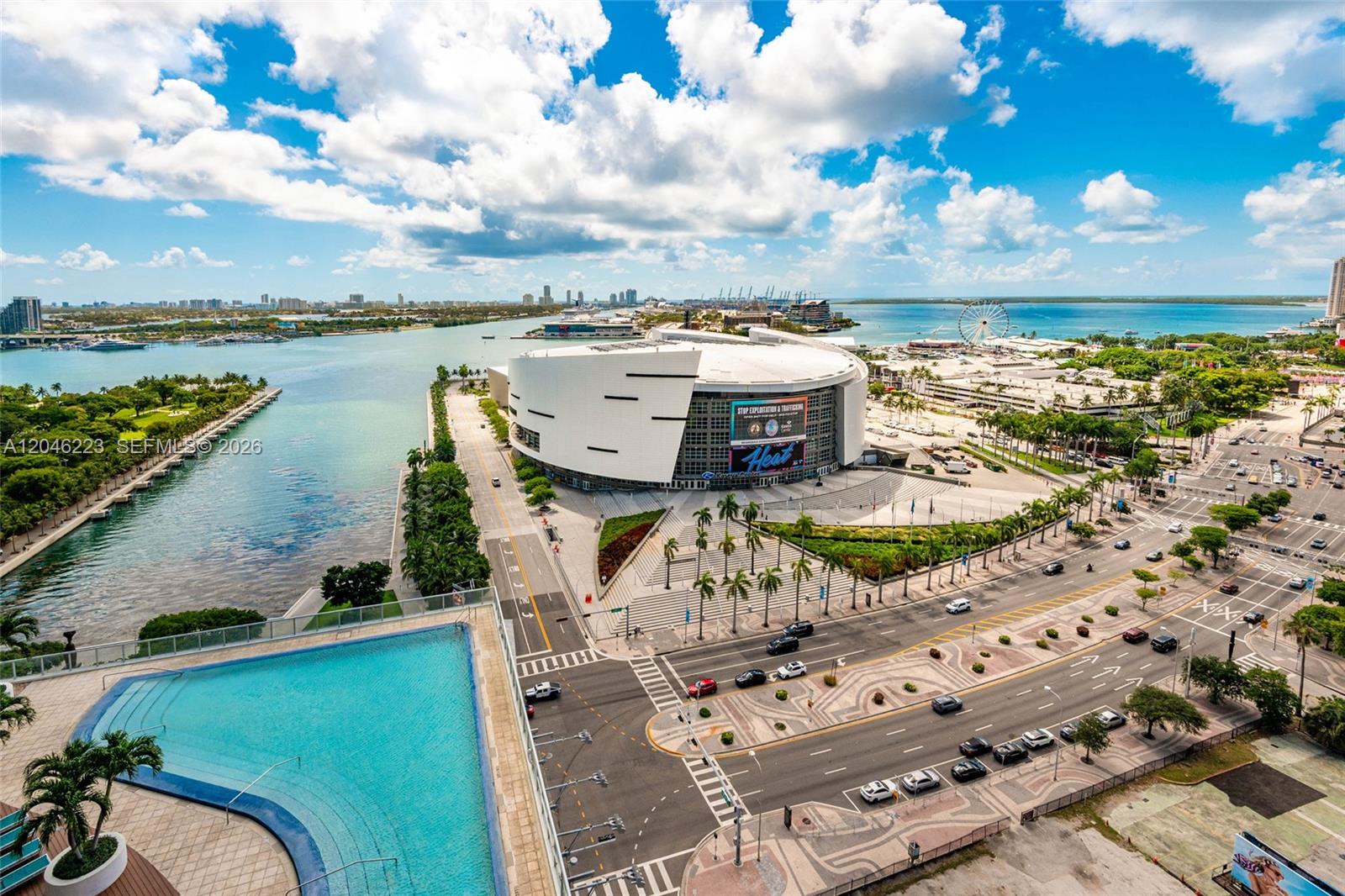 An aerial view shows a swimming pool overlooking the Kaseya Center and Miami waterfront — 888 Biscayne Blvd # 2002, Miami FL 33132, MIAMI, FL