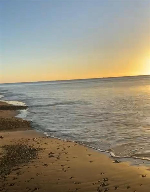 A view of a sandy beach and ocean at sunset under a clear sky — PR 3301 KM 2.6 INT PUNTA MELONES, BOQUERON, CABO ROJO, PR