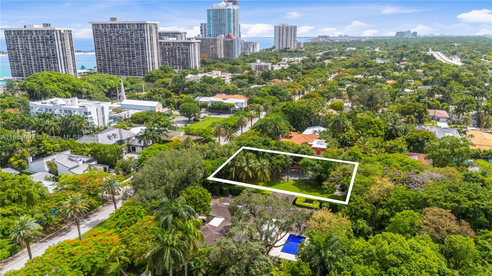 An aerial view shows a rectangular lot outlined in white amidst a lush, tree-filled neighborhood — 1644 S Miami Ave, Miami FL 33129, MIAMI, FL