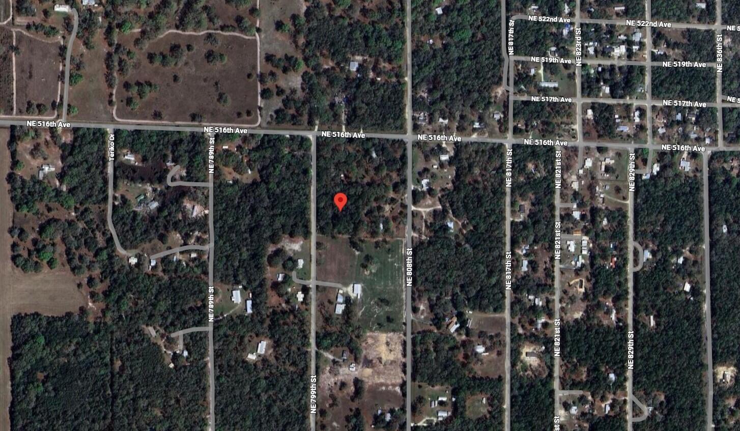 This is a satellite map view of a wooded residential area with a red location pin — Tbd NE 799th Street, FL 32680, FL