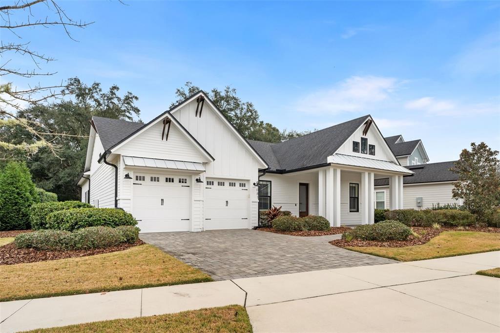 A white house with a two-car garage and a covered front porch — 11081 SW 38TH BOULEVARD, GAINESVILLE, FL