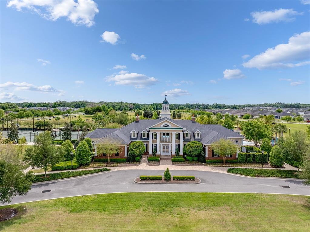 An aerial view of a community clubhouse with a cupola, surrounded by trees and landscaping — 11081 SW 38TH BOULEVARD, GAINESVILLE, FL