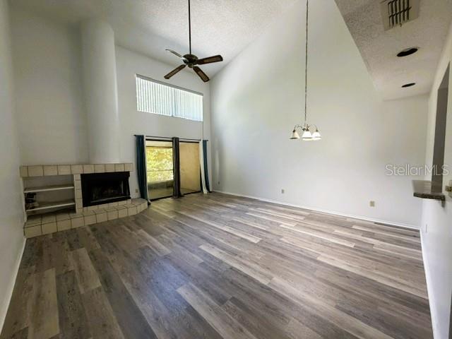 A living room features a vaulted ceiling, a fireplace, and wood-look flooring — 498 CLUB DRIVE, WINTER SPRINGS, FL