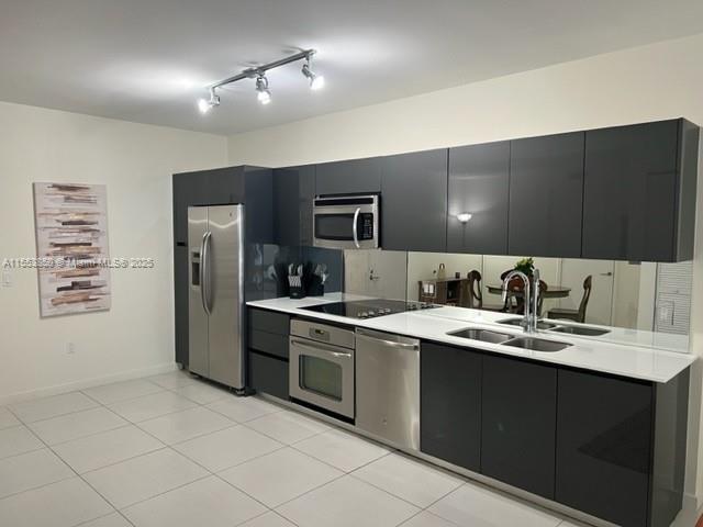 A modern kitchen features dark gray cabinets, stainless steel appliances, and white countertops — 31 SE 6th St # 1606, Miami FL 33131, MIAMI, FL