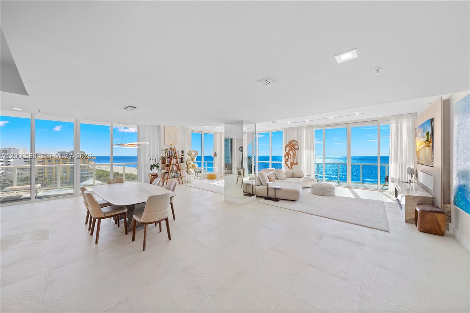 A bright, open-concept living and dining area features floor-to-ceiling windows overlooking the ocean — 50 S Pointe Dr, Miami Beach FL 33139, MIAMI BEACH, FL