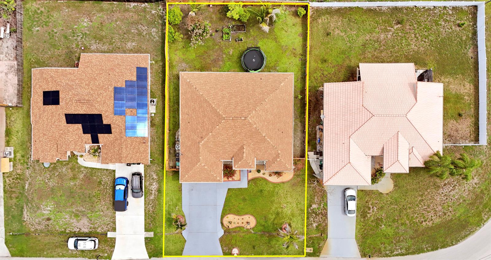 The exterior of a single-story house at night features a lit entryway and driveway — 611 SW Saragossa Avenue, FL 34953, FL