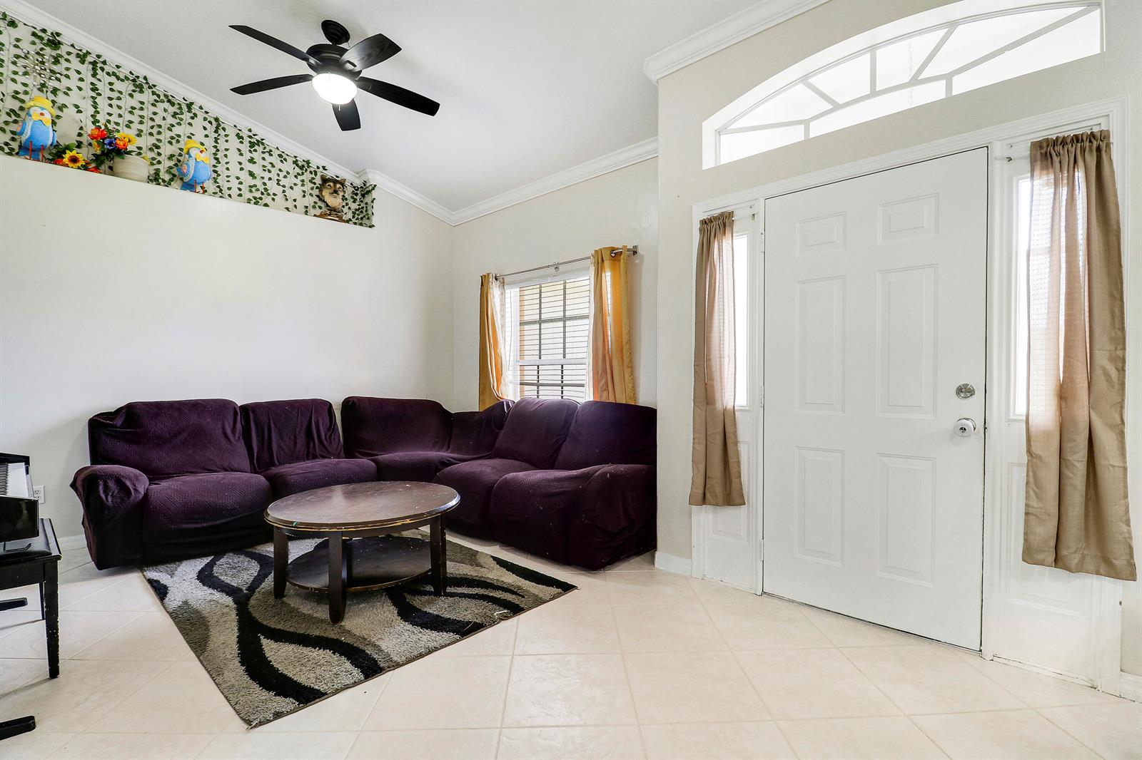 An aerial view shows a residential house with a fenced backyard and a concrete driveway — 611 SW Saragossa Avenue, FL 34953, FL