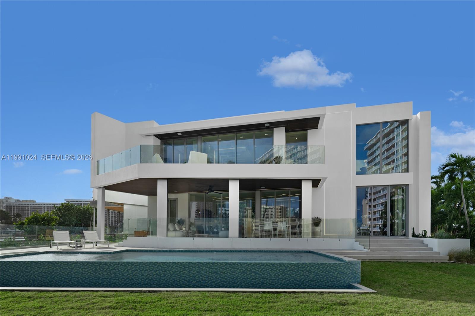 A modern two-story white house features a swimming pool, glass railings, and large windows — 501 Palm Dr, Hallandale Beach FL 33009, HALLANDALE BEACH, FL