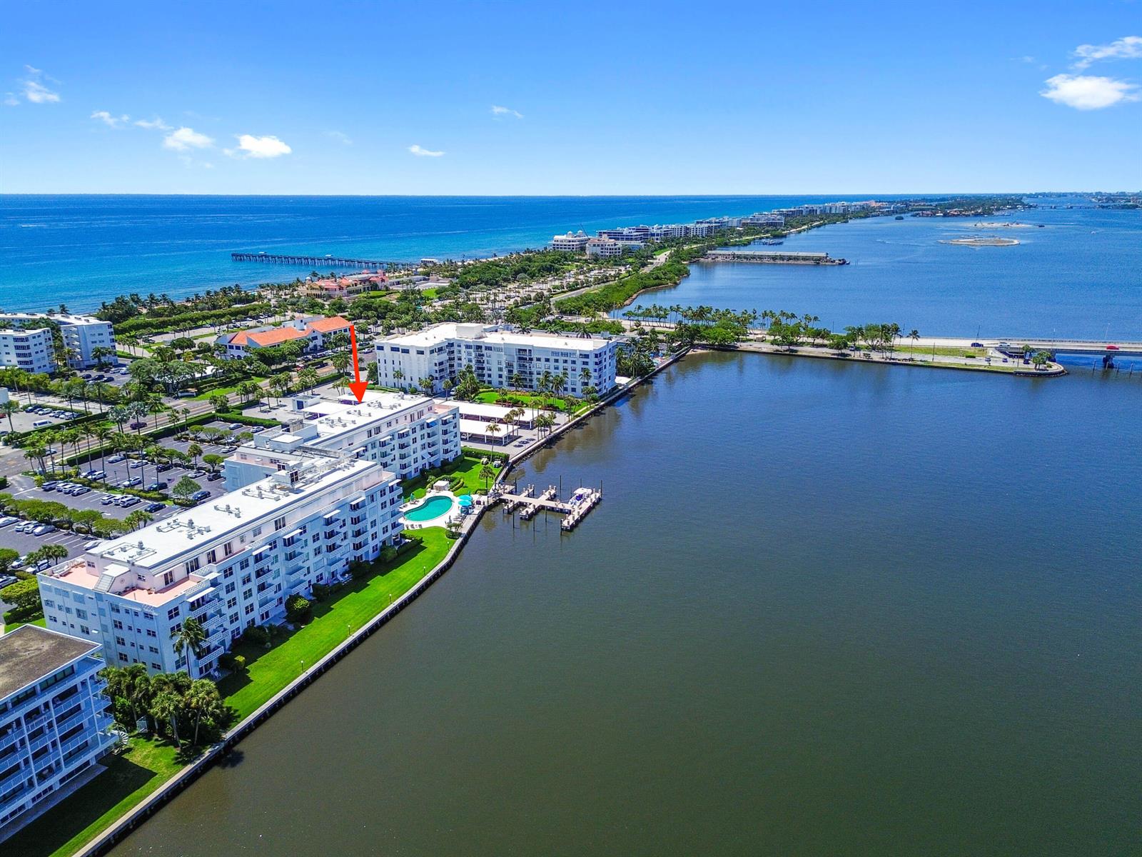 An aerial view shows waterfront apartment buildings with a swimming pool and boat docks — 2840 S Ocean Boulevard # 109, Palm Beach FL 33480, PALM BEACH, FL