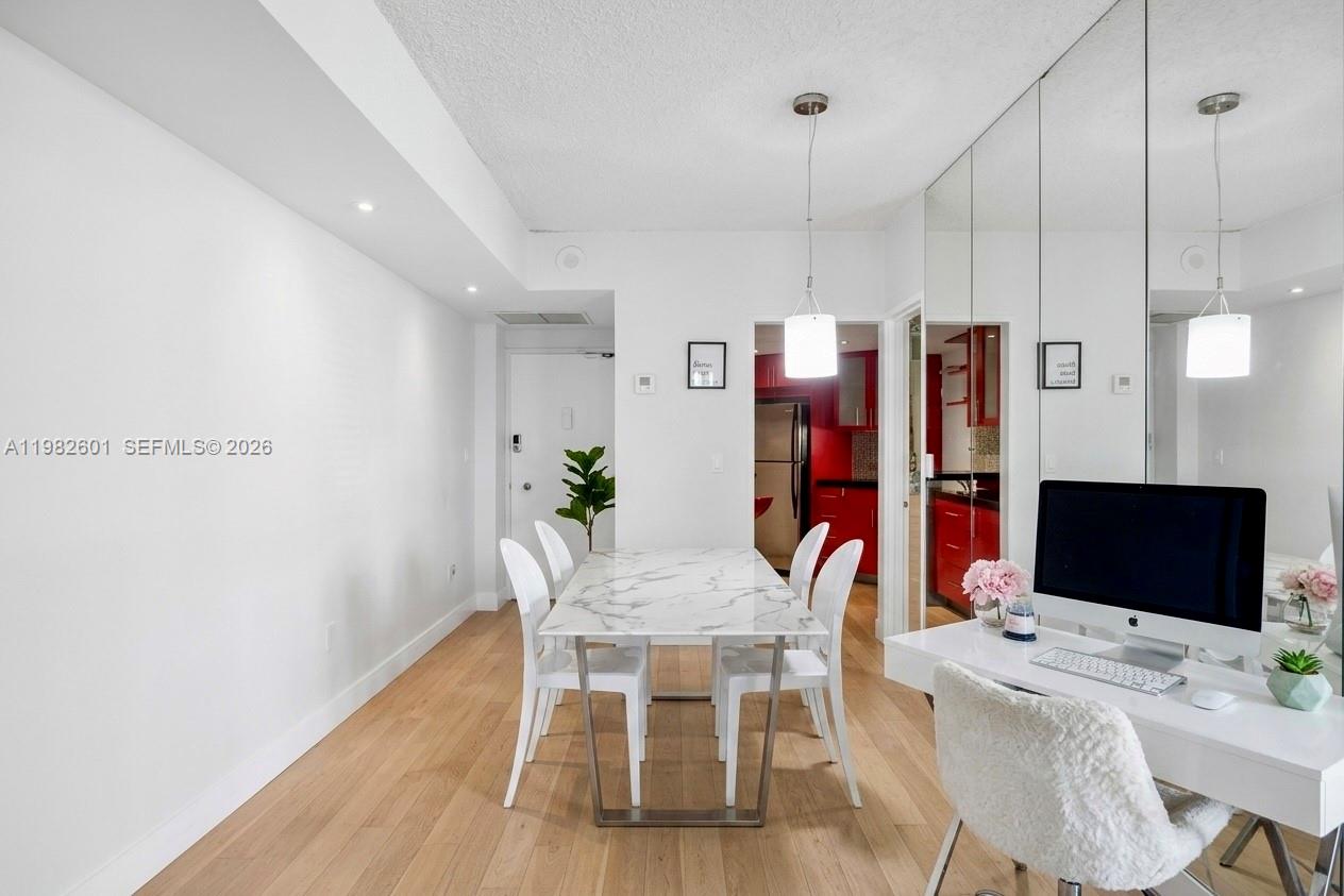 A dining area with a marble table and a desk with a computer — 801 Brickell Bay Dr # 1262, Miami FL 33131, MIAMI, FL