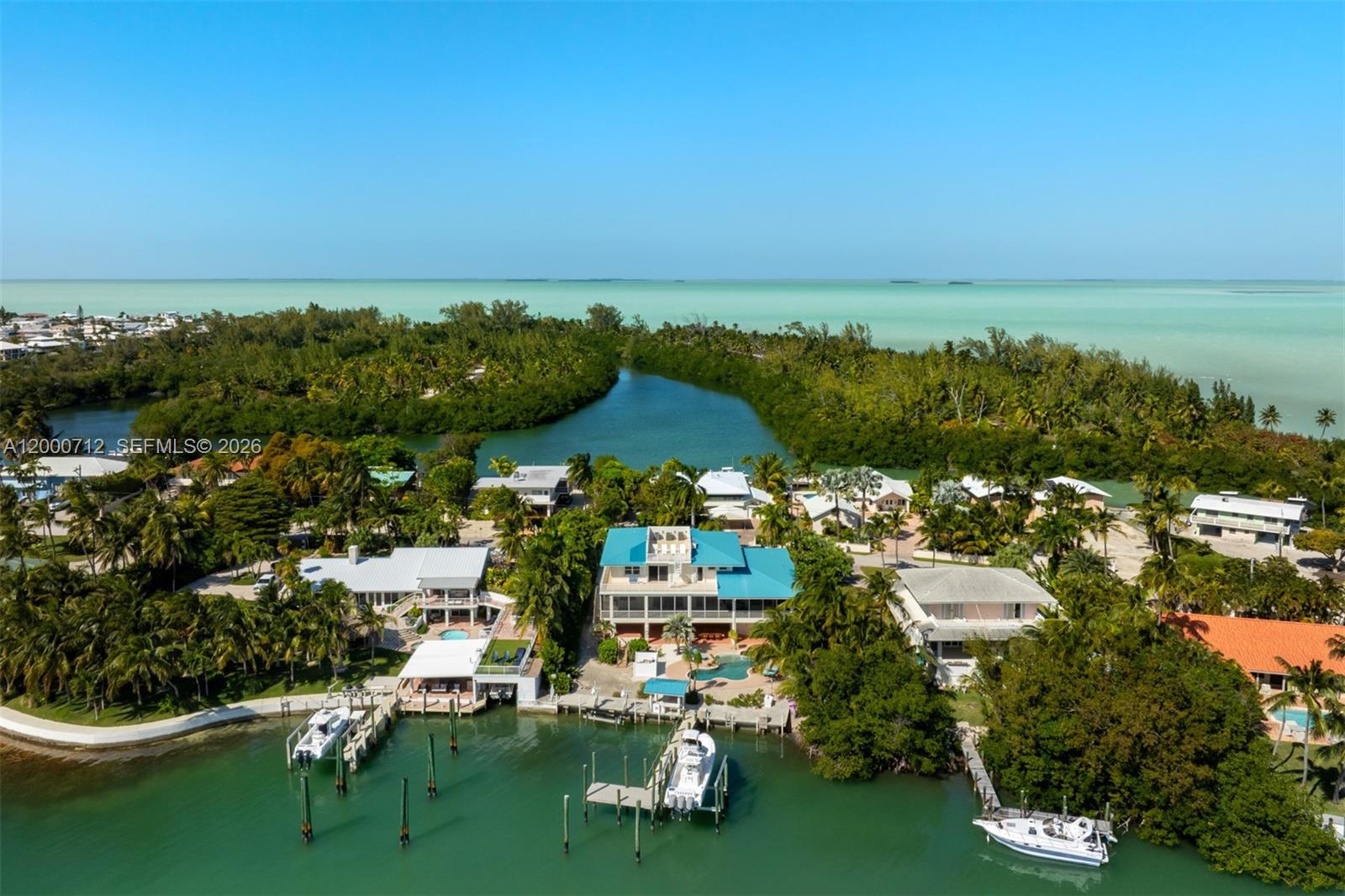 An aerial view shows waterfront homes with private docks and boats along a tropical canal — 137 Sapodilla Dr, Islamorada FL 33036, ISLAMORADA, FL