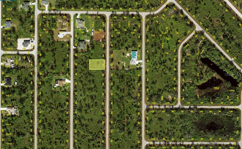 This is an aerial map showing a vacant rectangular lot highlighted in a residential subdivision — 3135 DWYER STREET, PORT CHARLOTTE, FL