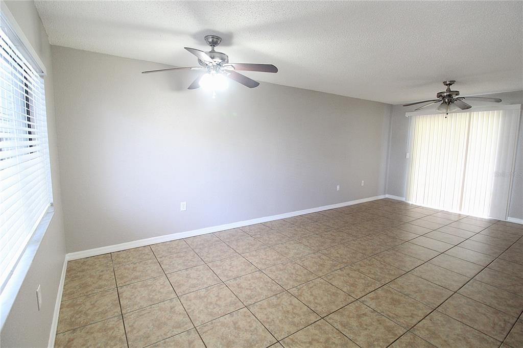 A kitchen features white cabinets, a white refrigerator, a dishwasher, and a double-basin sink — 5310 26TH STREET W UNIT 1502, BRADENTON, FL
