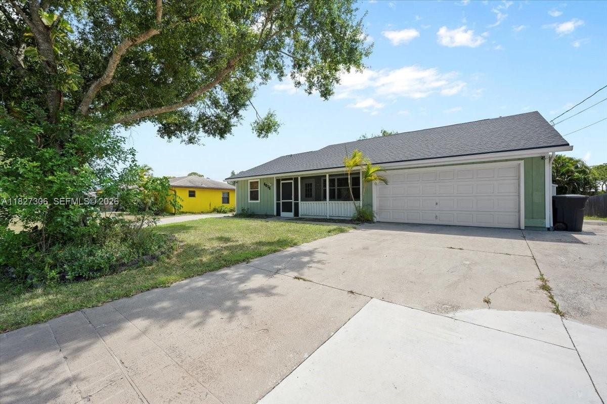 A single-story house with a green exterior, a screened porch, and a concrete driveway — 6015 Raintree, Fort Pierce FL 34982, FORT PIERCE, FL