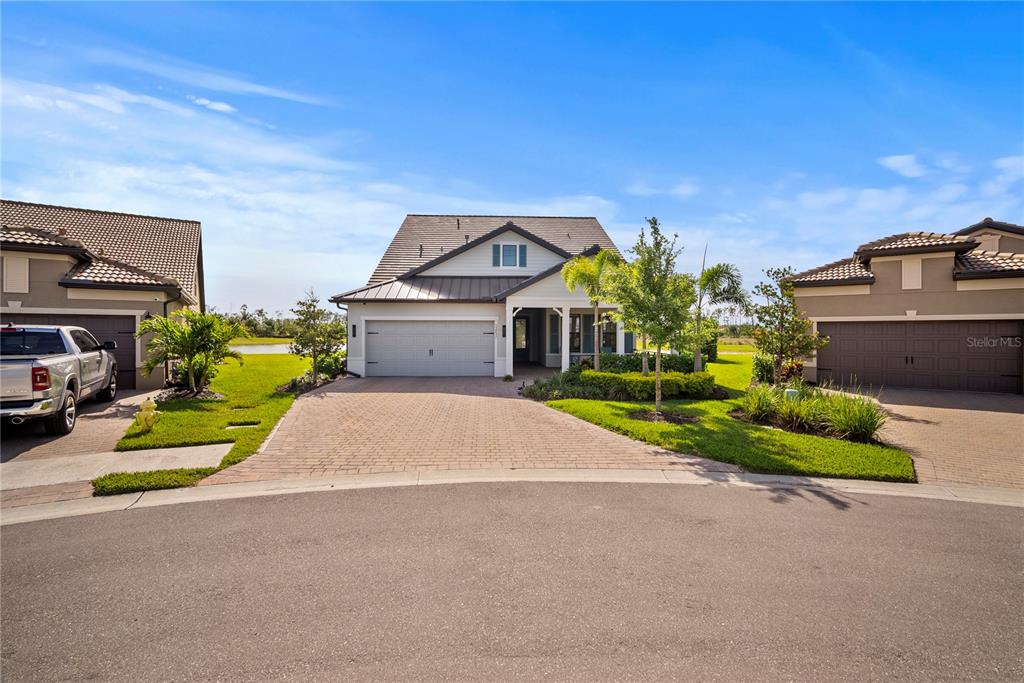 A single-story house with a paved driveway, a two-car garage, and a landscaped front yard — 12537 AQUA RESERVE COURT, FORT MYERS, FL