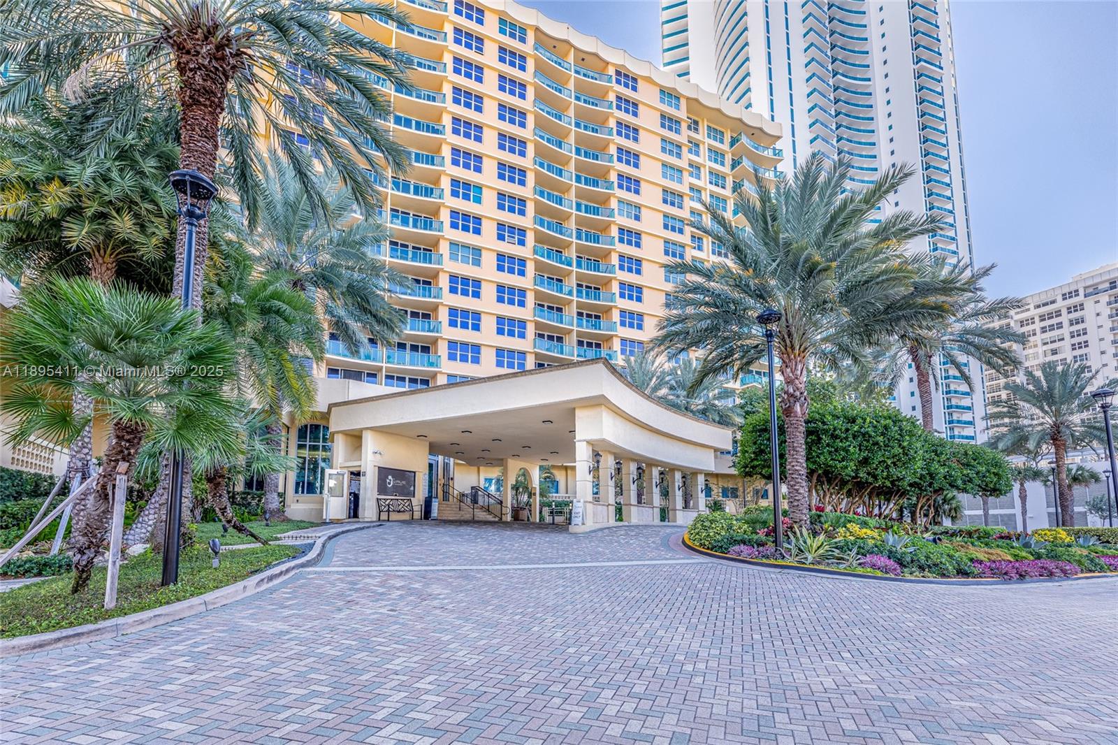A paved driveway leads to the covered entrance of a tall, multi-story residential building — 2501 S Ocean Dr # 439, Hollywood FL 33019, HOLLYWOOD, FL