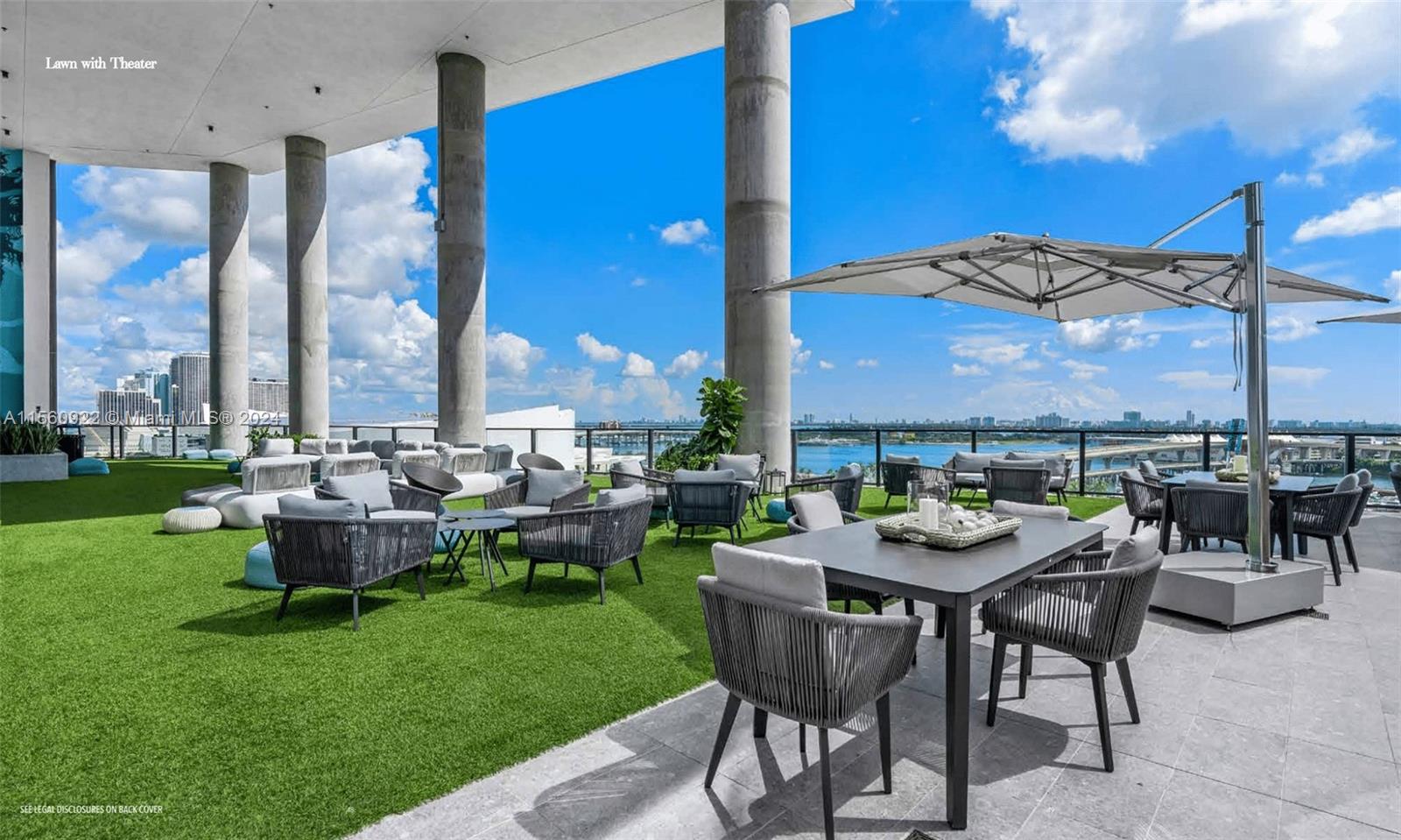 An outdoor rooftop terrace features artificial turf, lounge seating, dining tables, and a large umbrella — 398 NE 5th St # 4708, Miami FL 33132, MIAMI, FL