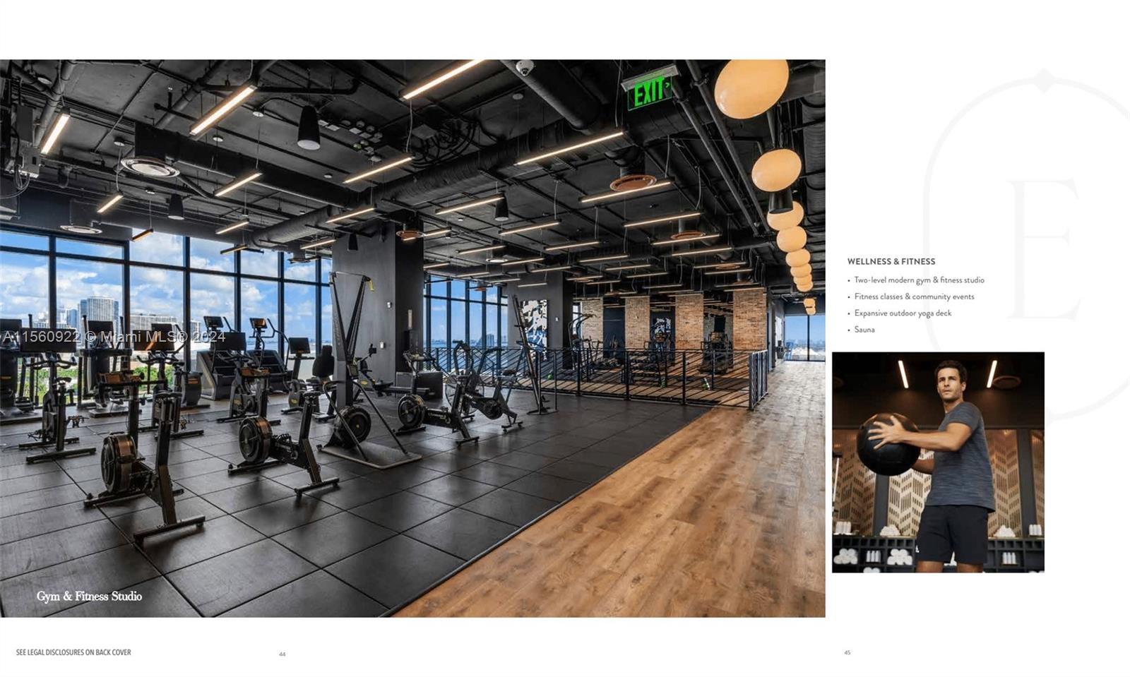 A modern gym features black rubber flooring, wood accents, and rows of fitness equipment — 398 NE 5th St # 4708, Miami FL 33132, MIAMI, FL