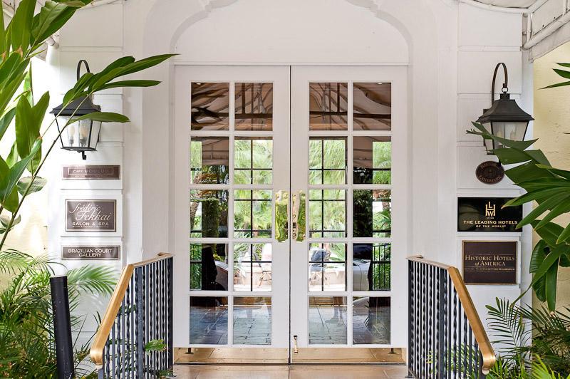 A white double door entrance with glass panels, flanked by wall lanterns and signage — 301 Australian Avenue # 306, Palm Beach FL 33480, PALM BEACH, FL