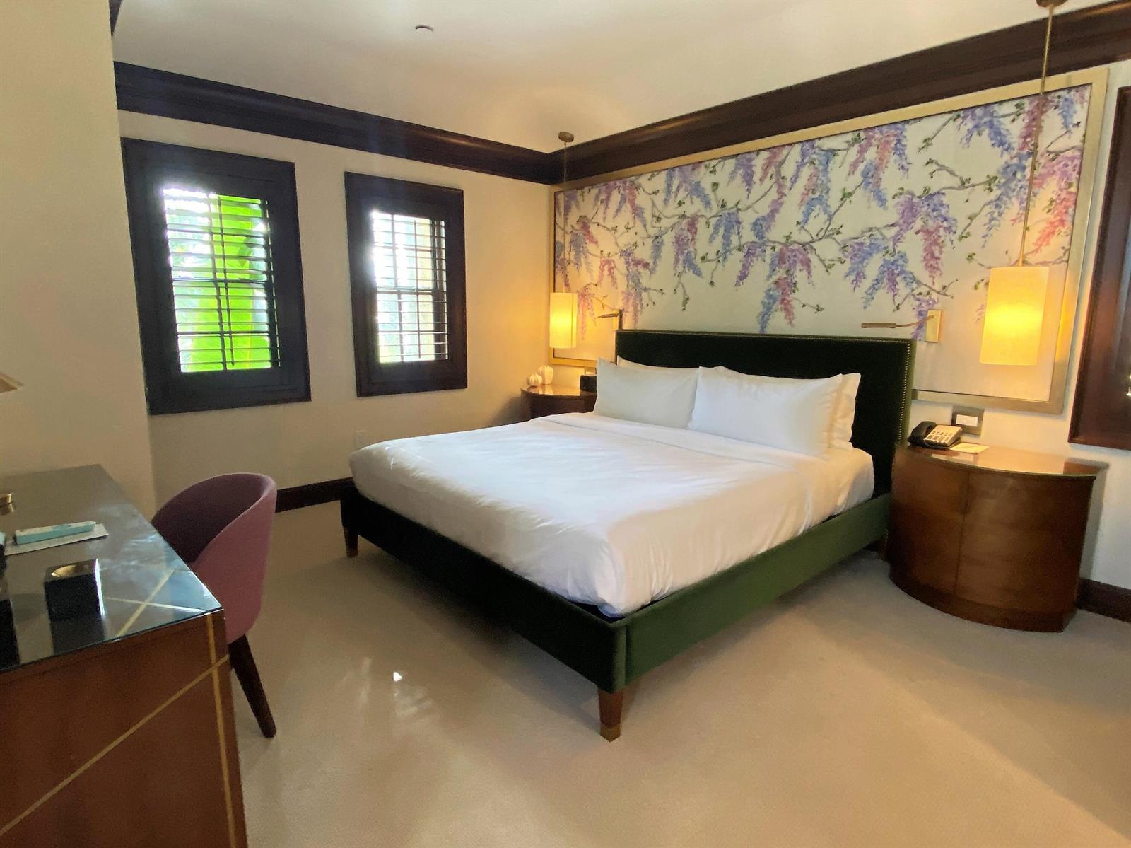 A bedroom features a green velvet bed, floral wall art, and two dark-framed windows — 301 Australian Avenue # 306, Palm Beach FL 33480, PALM BEACH, FL