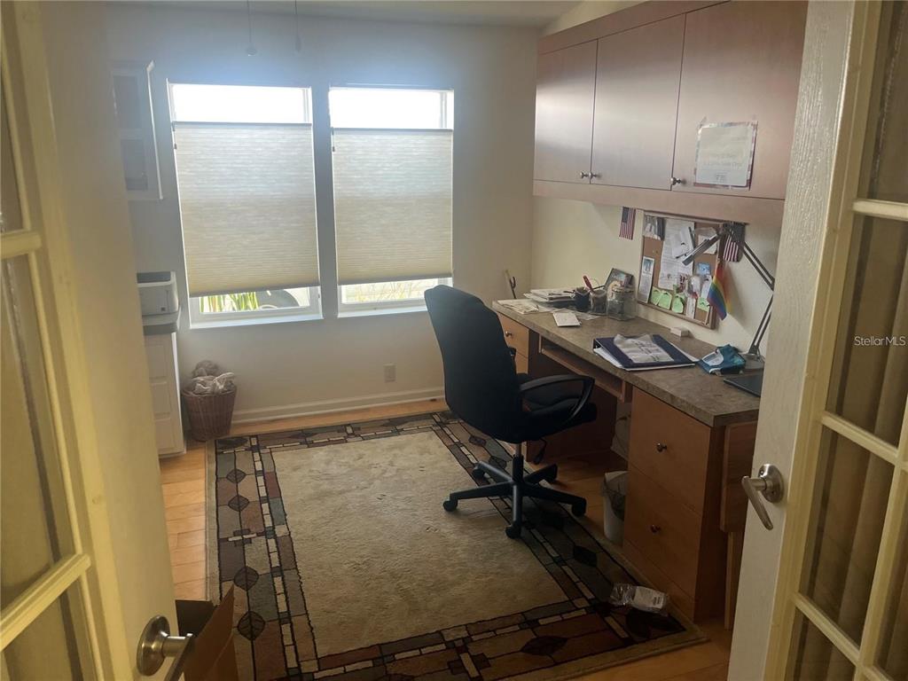A home office features a built-in desk, overhead cabinets, a rug, and two windows — 3364 GOLDA CIRCLE, NORTH FORT MYERS, FL