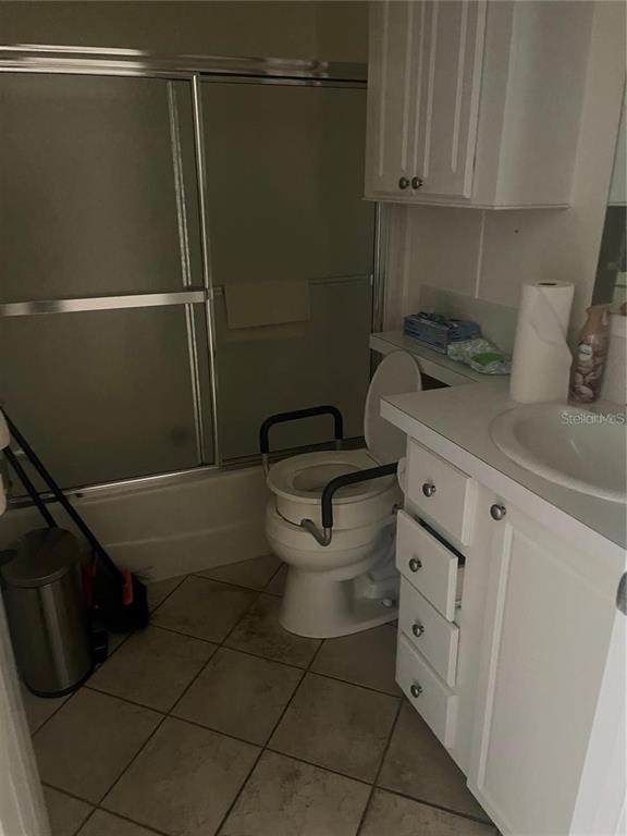 A bathroom features a tiled floor, a shower-tub combination, a vanity, and a raised toilet — 3364 GOLDA CIRCLE, NORTH FORT MYERS, FL
