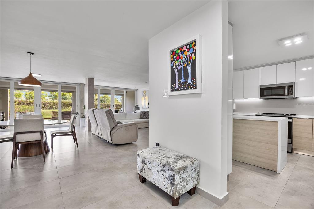 An open-concept living area features a modern kitchen, dining space, and a neutral-toned seating area — M1 COSTA DORADA UNIT M1, DORADO, PR
