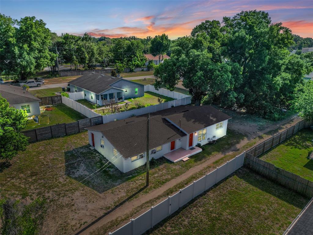 An aerial view shows a single-story house with a dark roof and white exterior walls — 1460 MARVIN C ZANDERS AVENUE UNIT A, APOPKA, FL