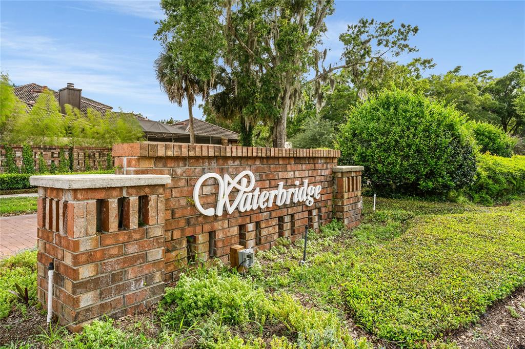 A brick entrance monument with the name Waterbridge stands in a landscaped residential area — JESSICA COURT, WINTER PARK, FL