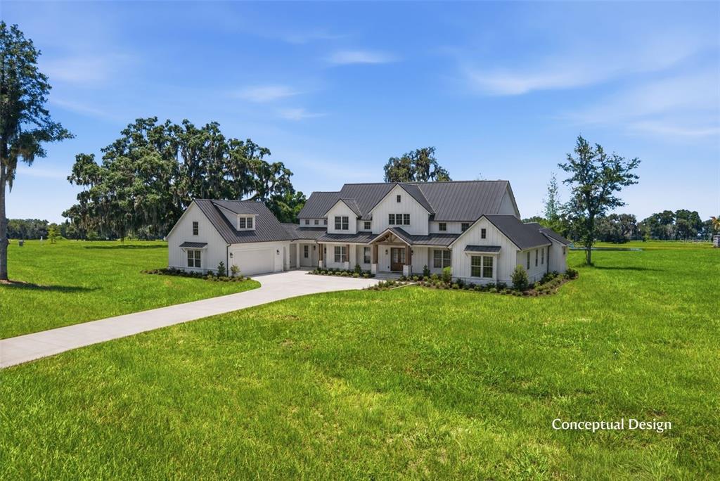 This is a digital rendering of a modern farmhouse with a metal roof and siding — TBD (Lot 22-W) SW 138TH LOOP, DUNNELLON, FL