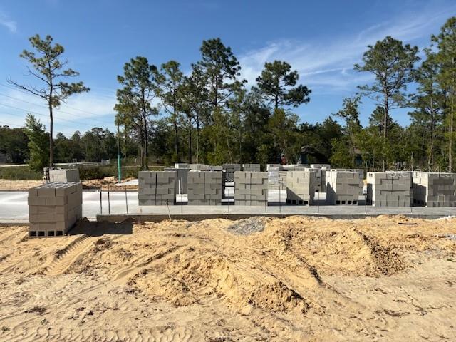 A newly constructed single-story house with a tan stucco exterior and a sandy front yard — 5535 SW 121ST TERRACE, OCALA, FL