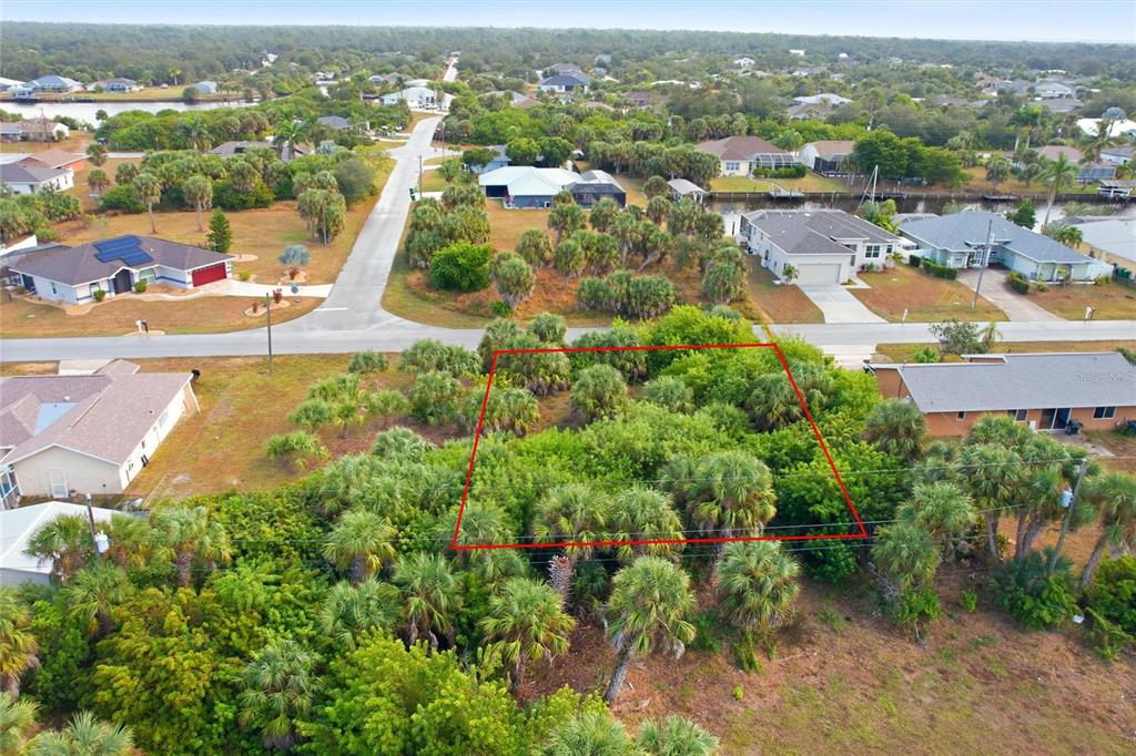 An aerial view shows a vacant, wooded residential lot outlined in red — 4073 ROSE ARBOR CIRCLE, PORT CHARLOTTE, FL