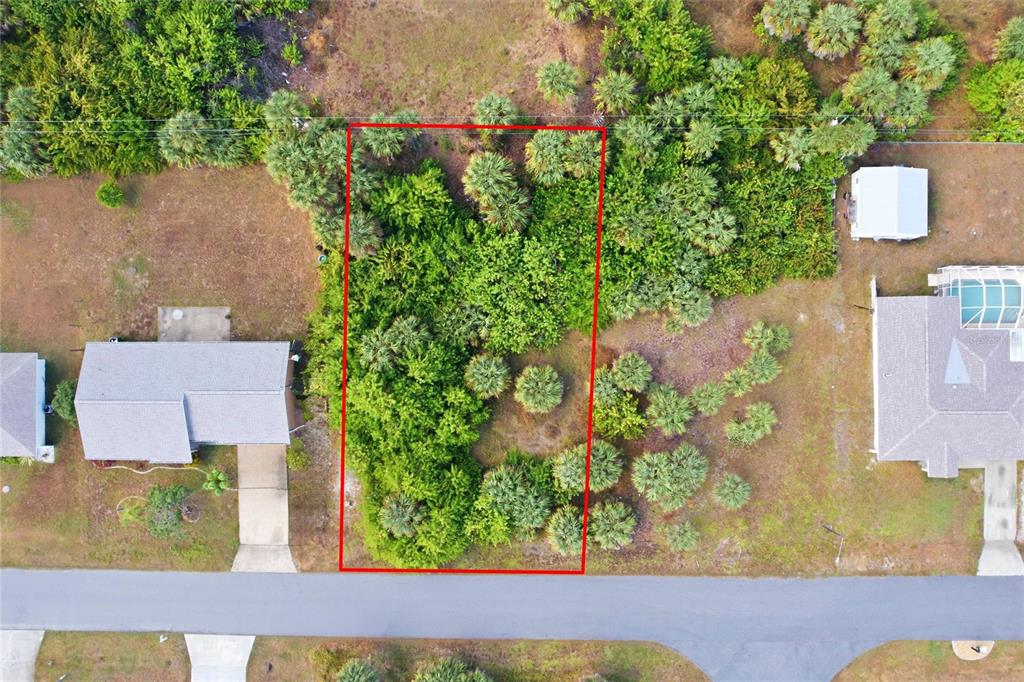 An aerial view shows a rectangular, tree-covered vacant lot outlined in red between two houses — 4073 ROSE ARBOR CIRCLE, PORT CHARLOTTE, FL