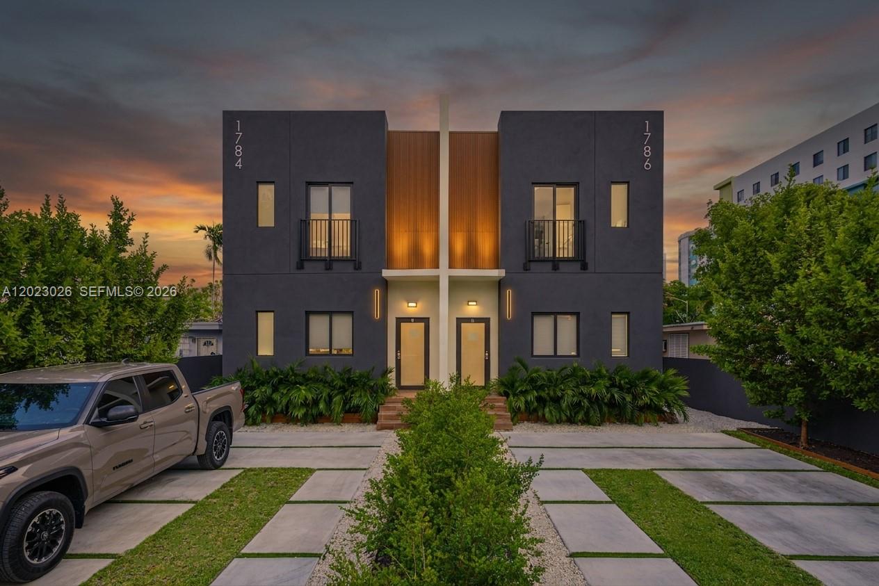 A modern two-story duplex with dark gray exterior walls and a central wood-paneled accent — 1784 & 1786 NW 31st St, Miami FL 33142, MIAMI, FL
