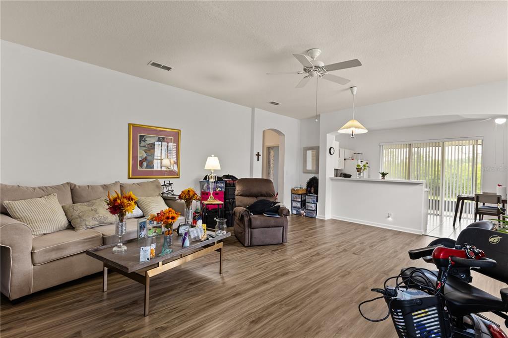 A laundry room features white cabinets above a washer and dryer next to a door — 307 HERON POINT WAY, DELAND, FL