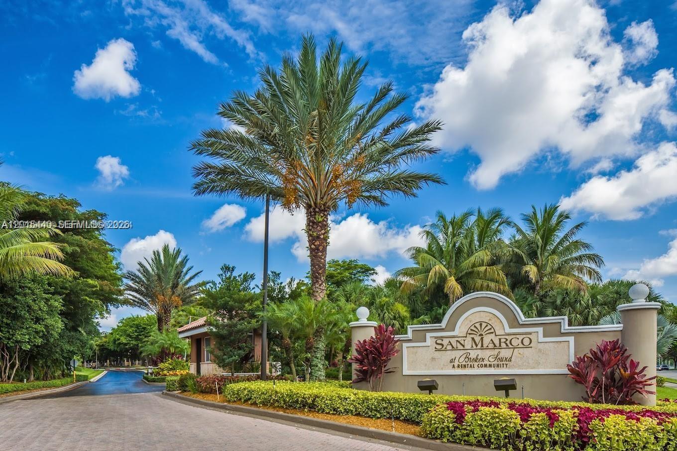 A palm tree stands behind a sign for San Marco at Broken Sound near a road — 5555 N Military Trl, Boca Raton FL 33496, BOCA RATON, FL