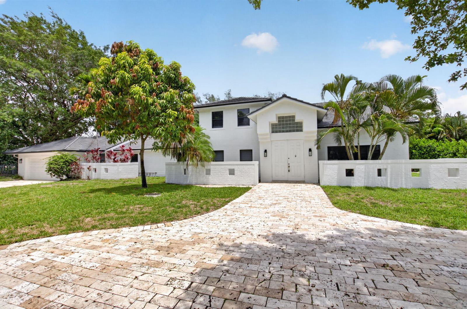 A two-story white house with a stone paver driveway and a low perimeter wall — 8044 Twin Lake Drive, Boca Raton FL 33496, BOCA RATON, FL