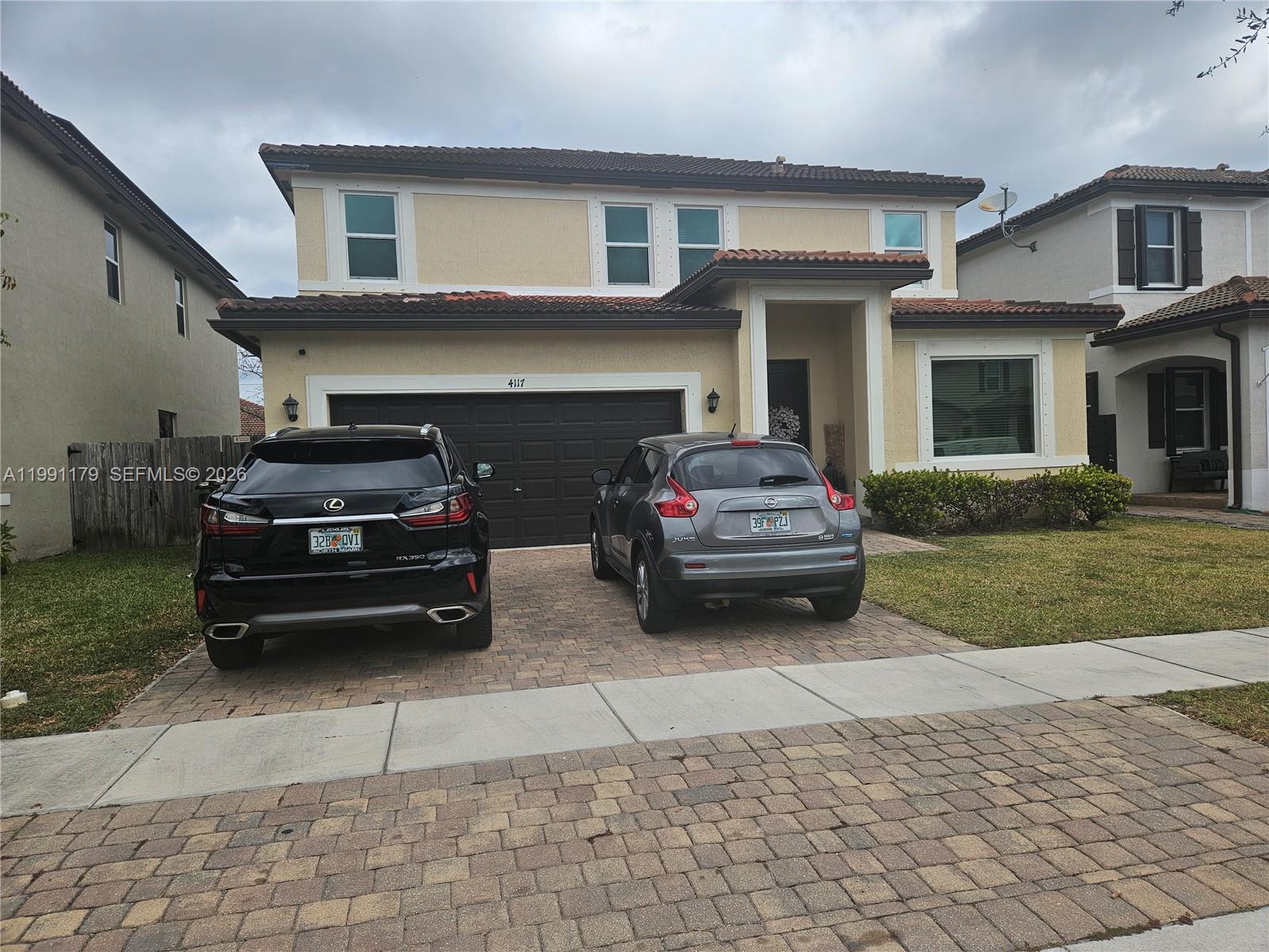 A two-story stucco house with a tile roof and a two-car garage — 4117 NE 21st St, Homestead FL 33033, HOMESTEAD, FL