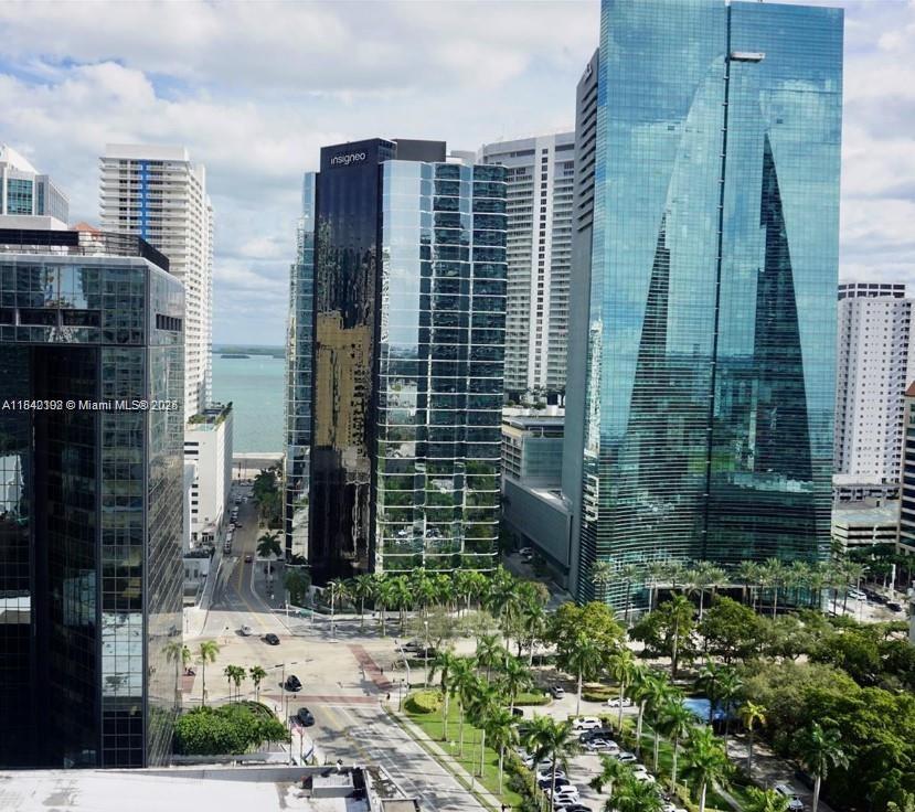 An elevated view of a city skyline featuring modern glass skyscrapers and palm-lined streets — 1250 S Miami Ave # 2006, Miami FL 33130, MIAMI, FL