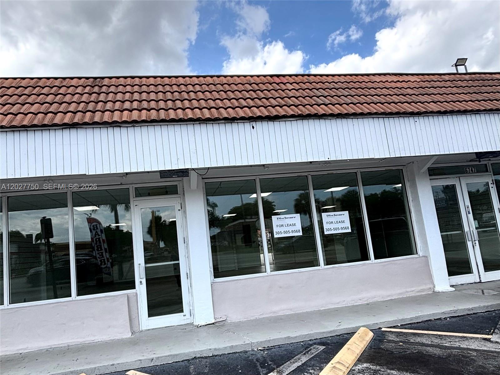 A commercial storefront with a tiled roof and large glass windows available for lease — 6741 SW 8th St # 6747, Miami FL 33144, MIAMI, FL