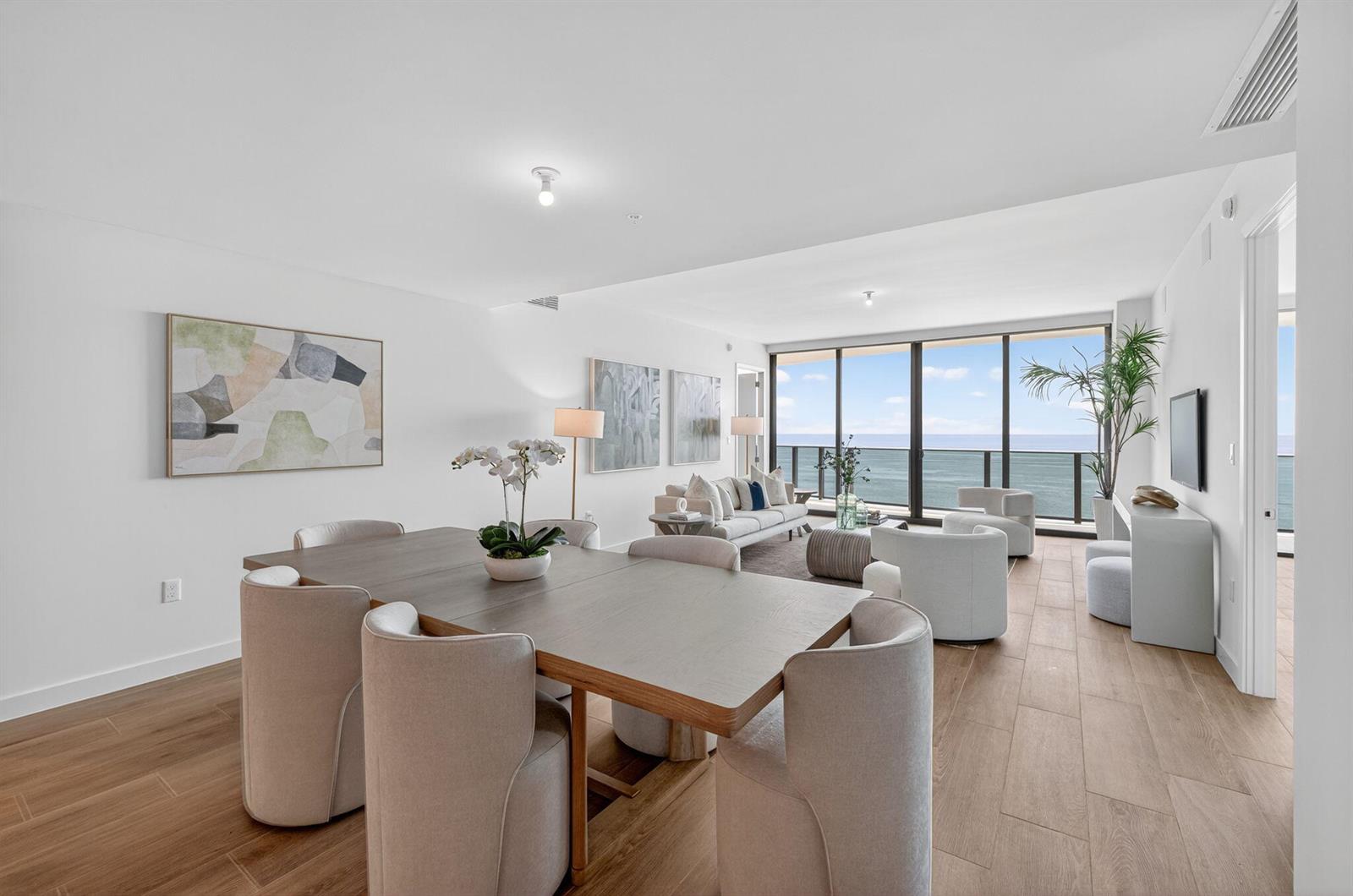 A dining area and living room with ocean views and light wood flooring — 900 N Ocean Boulevard # 1702, Pompano Beach FL 33062, POMPANO BEACH, FL