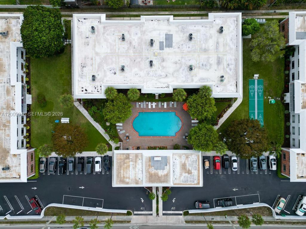 An aerial view shows a residential building with a central swimming pool and parking lot — 400 S Cypress Rd # 424, Pompano Beach FL 33060, POMPANO BEACH, FL