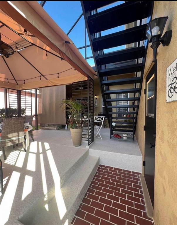 A covered patio features a metal staircase, a gazebo, and a brick-patterned walkway — 3406 MORELYN CREST CIRCLE, ORLANDO, FL