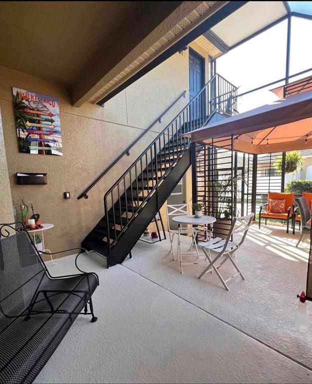 A covered patio features a metal staircase, outdoor furniture, and a gazebo — 3406 MORELYN CREST CIRCLE, ORLANDO, FL