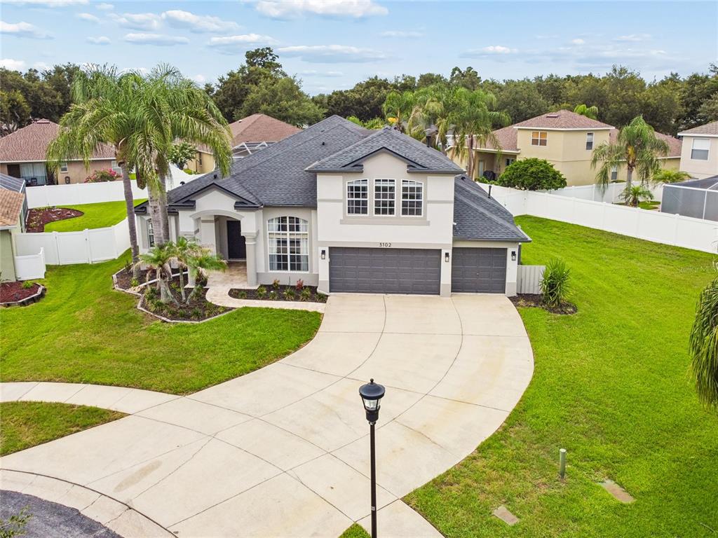 An aerial view of a single-story suburban house with a gray roof and concrete driveway — 3102 WHITE PHEASANT PLACE, VALRICO, FL