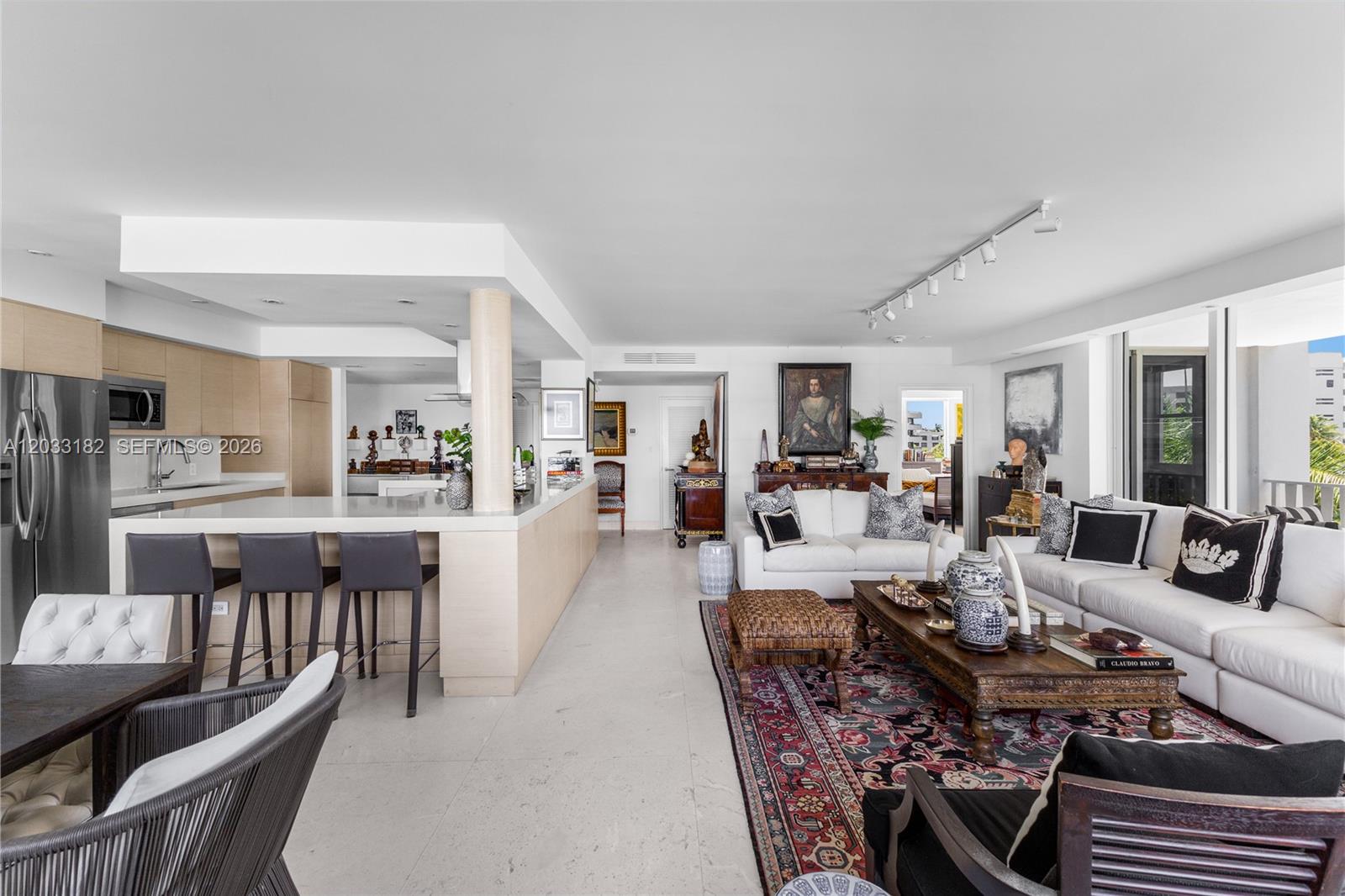 An open-concept living area features a kitchen with bar seating and a spacious lounge — 200 Ocean Lane Drive # 409, Key Biscayne FL 33149, KEY BISCAYNE, FL