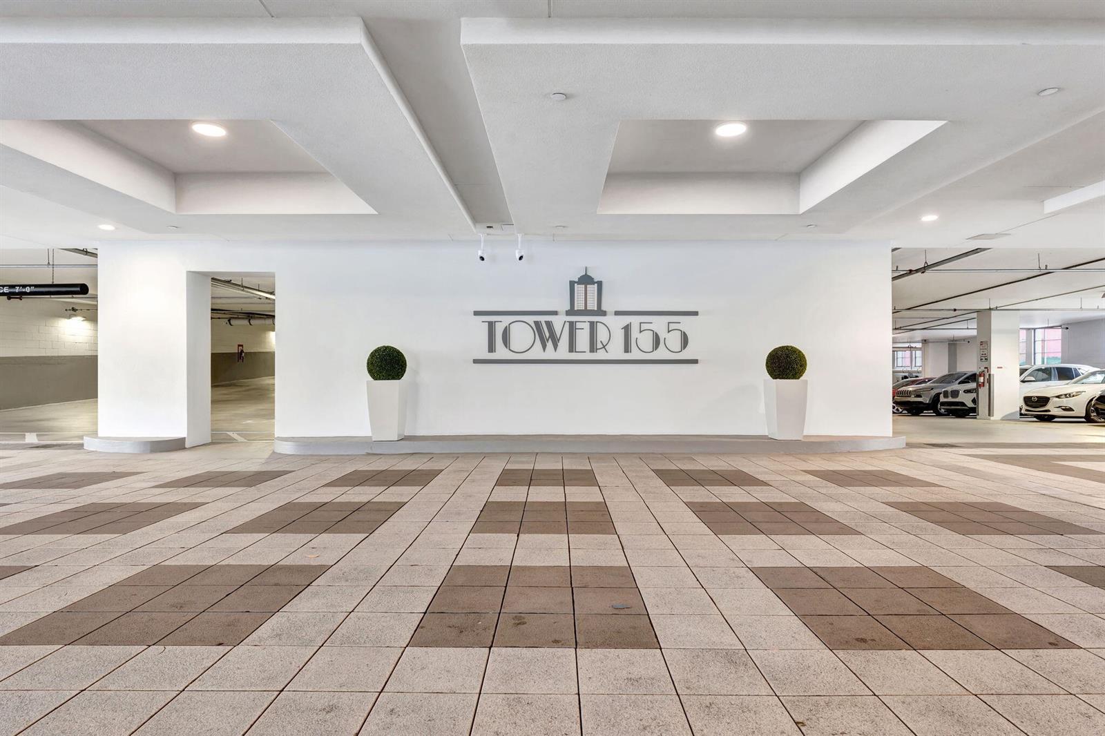 A covered parking garage entrance features a white wall with the Tower 155 logo — 155 E Boca Raton Road, Boca Raton FL 33432, BOCA RATON, FL
