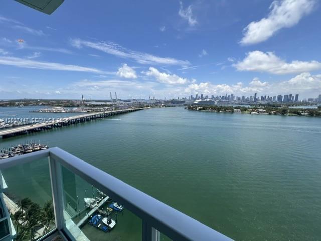 A high-angle view from a balcony overlooking a bay, a bridge, and a city skyline — 650 West Ave # 2109, Miami Beach FL 33139, MIAMI BEACH, FL