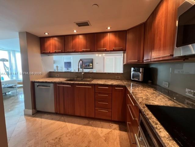 A kitchen features wood cabinets, granite countertops, a stainless steel dishwasher, and tile flooring — 650 West Ave # 2109, Miami Beach FL 33139, MIAMI BEACH, FL