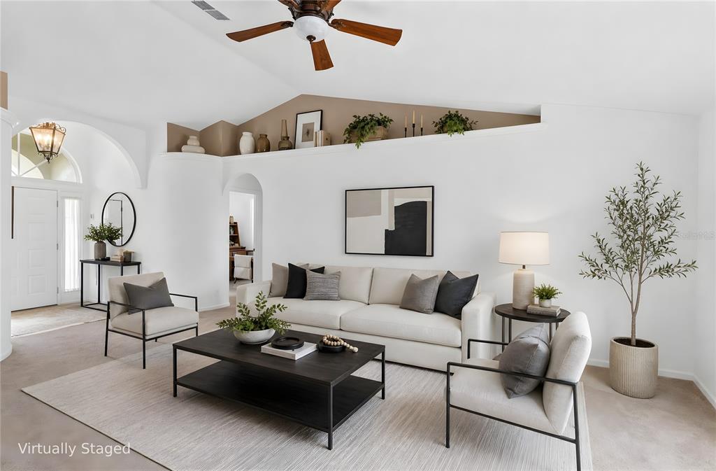 A living room features red sofas, a beige armchair, a wooden cabinet, and sliding glass doors — 5340 N LAKE BURKETT LANE, WINTER PARK, FL
